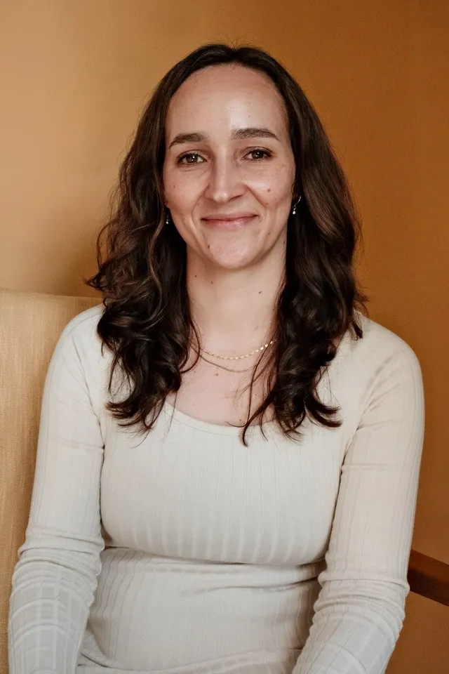 Dr. Clare Edwards, PhD, licensed psychologist, seated in an armchair at Coastal Therapy Group in Vista, CA