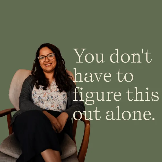 Dr. C. Julieta Aguilera Rice, PhD, licensed psychologist and Connected Parenting group leader, seated in a therapy chair against a sage green background at Coastal Therapy Group