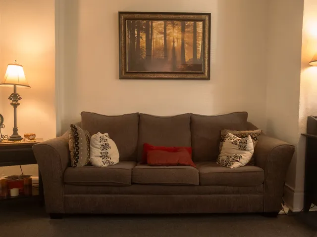 Therapy room with a couch and warm lamplight at Coastal Therapy Group's Pasadena office